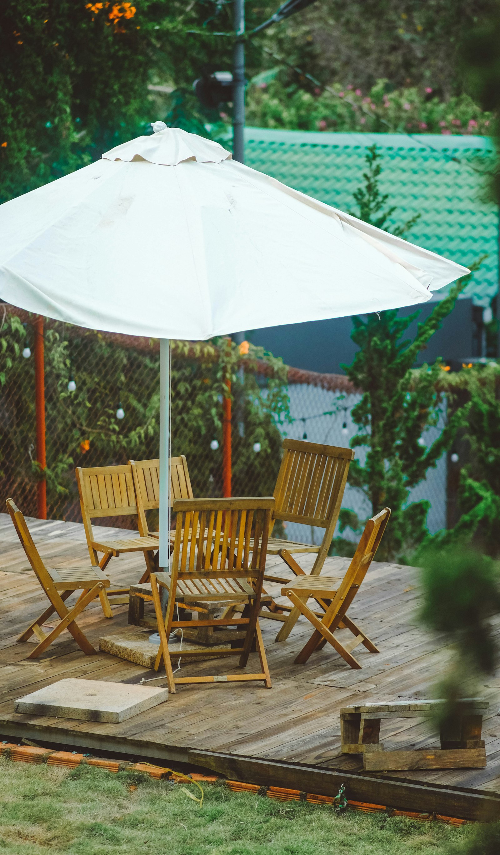 Wooden backyard deck with table, chairs and patio umbrella