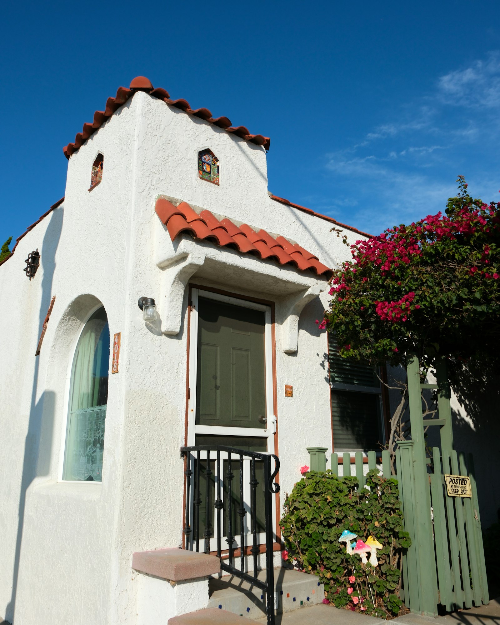 Clean white stucco home with red clay tile roof