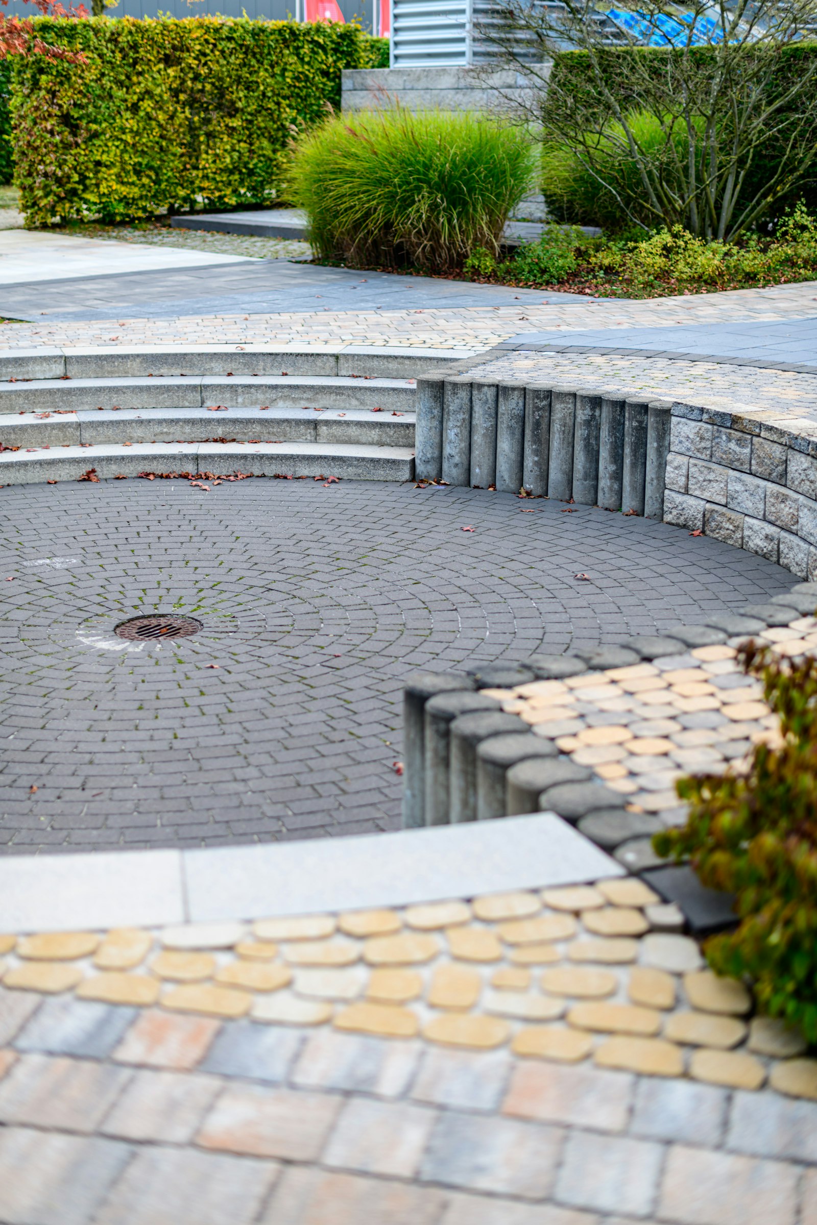 Curved paver walkway with stone steps and landscaping