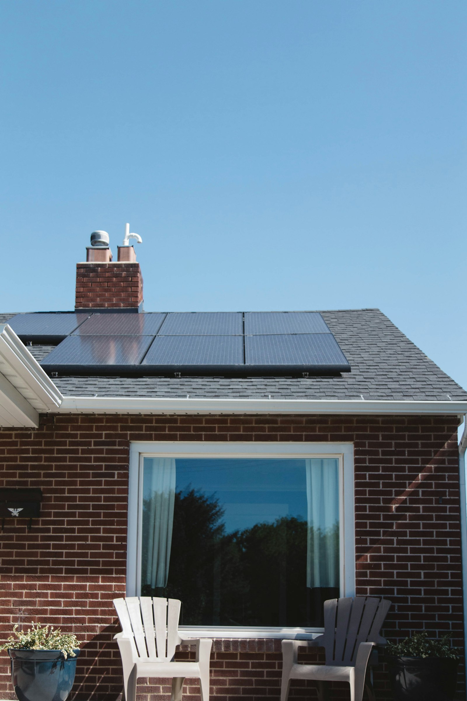 Brick home with a clean tile roof and solar panels