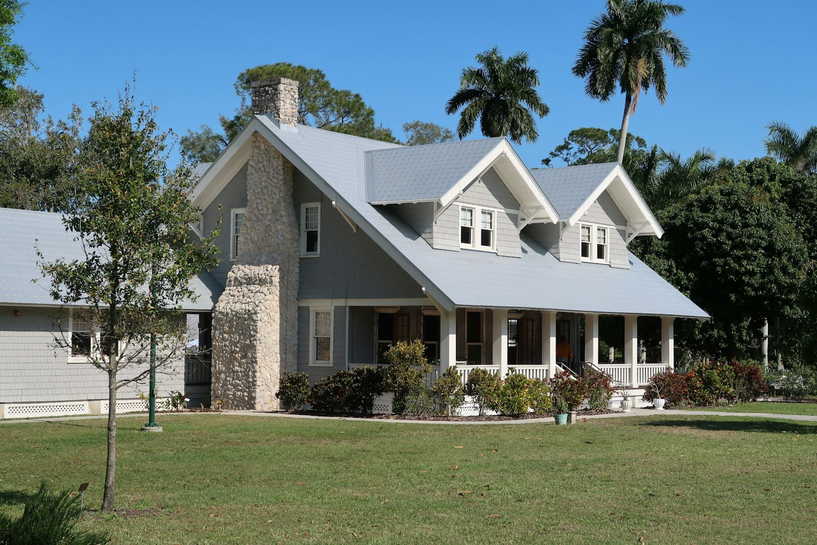 Florida estate home exterior with clean roof under blue sky